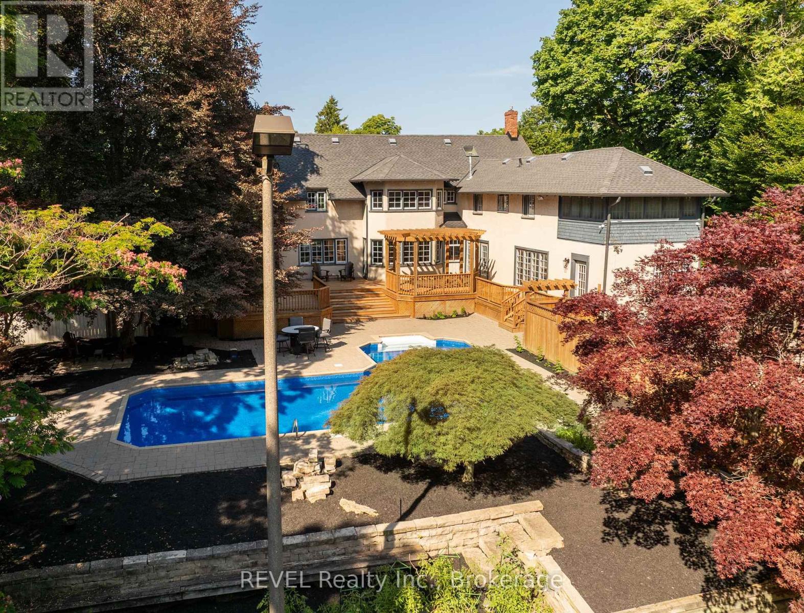 Backyard pool and patio photo of 166 Queen Street, Niagara Region property listing by Ken Peterkin